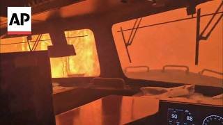 Video shows a train crew surrounded by intense flames in Canada