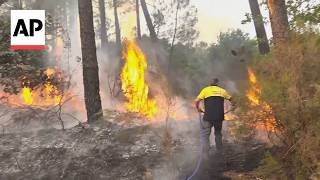 AP reporter shows wildfires burning in France as 250,000 people evacuated so far