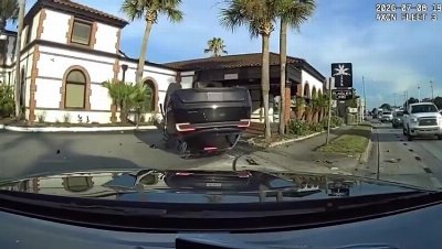 Police dashcam captures moment speeding Tesla flips in deadly Florida crash that killed scooter rider