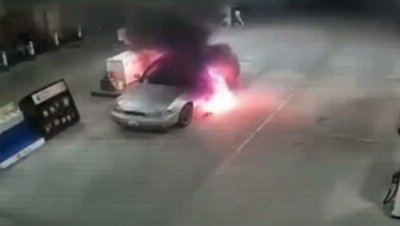 Driver and passenger flee through flames as car erupts into fireball at petrol pump